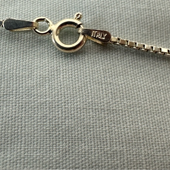 Silver pendant with gold star on the front and an arrow on the back. - Picture 3 of 5